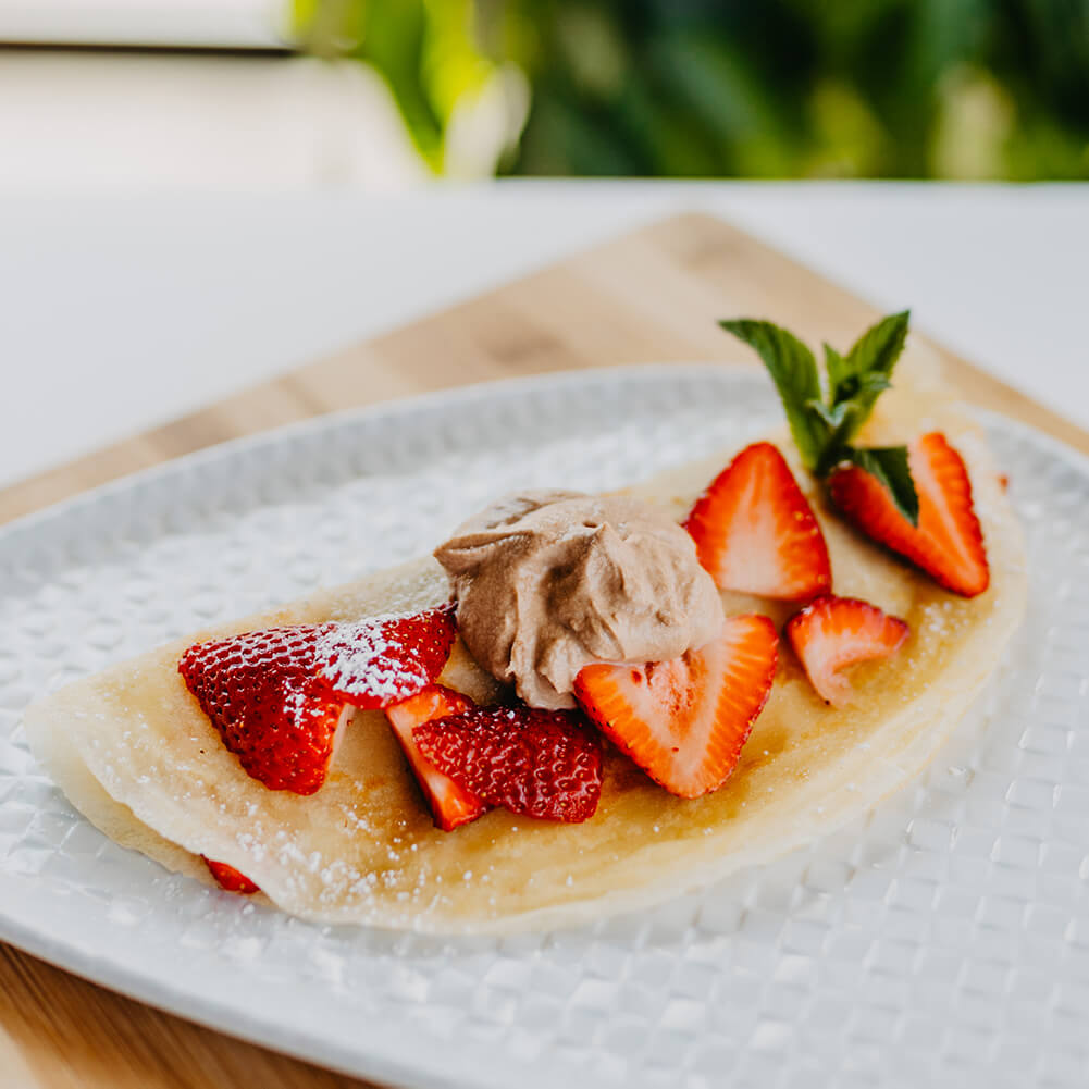 Thin Sweet Crepes Spread with Cream of Nutella and Topped with Fresh Sliced Bananas
